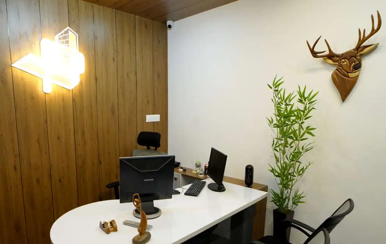 A cabin in the VIPRA HOMES office with timber wall panelling and an illuminated VIPRA logo