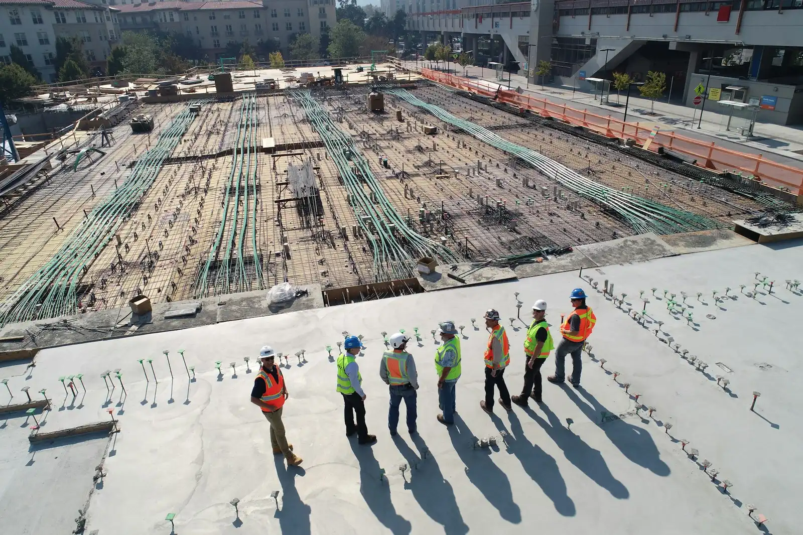 A project team in safety gear reviewing a construction site
