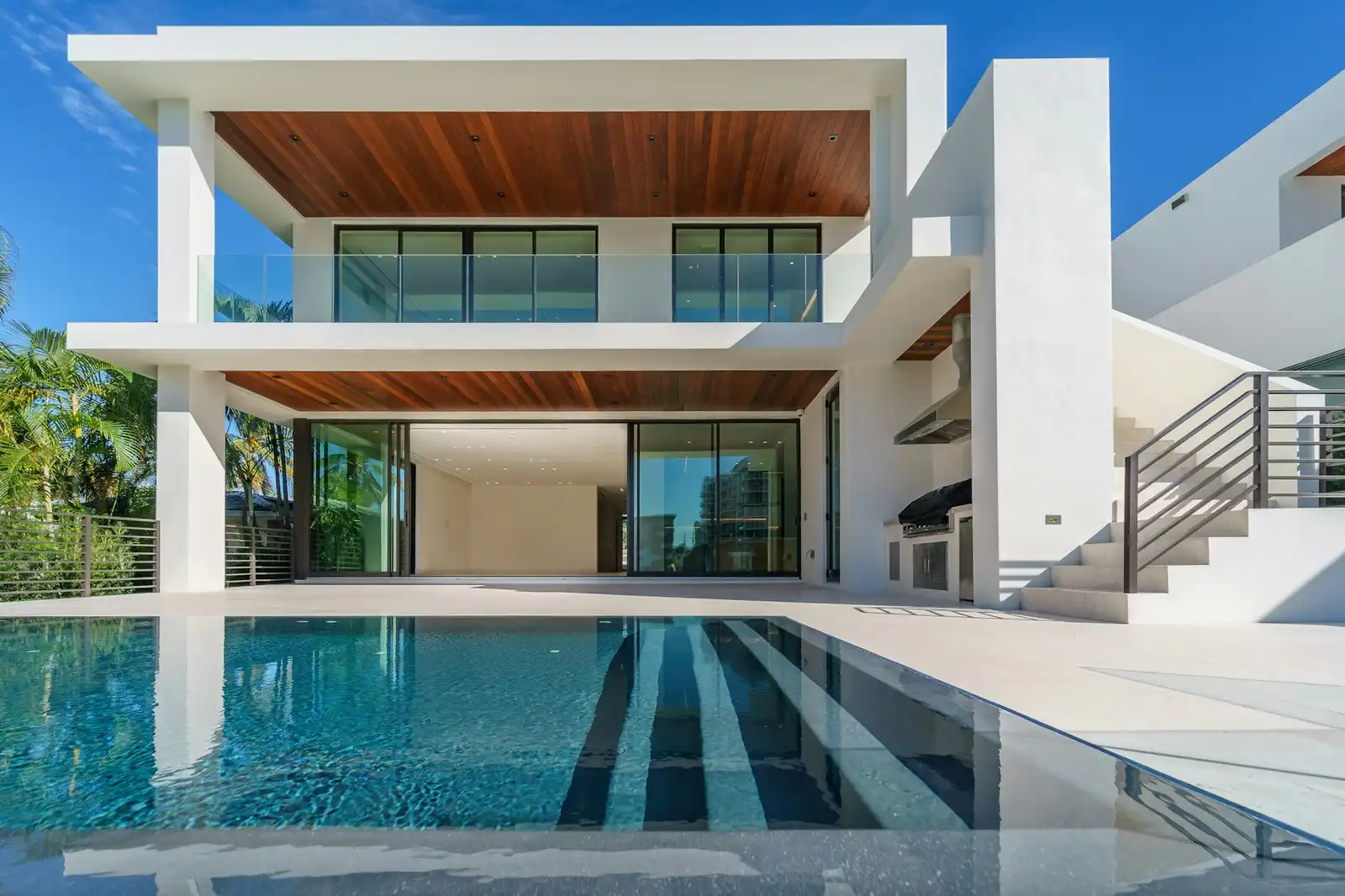 A completed white contemporary residence with a swimming pool