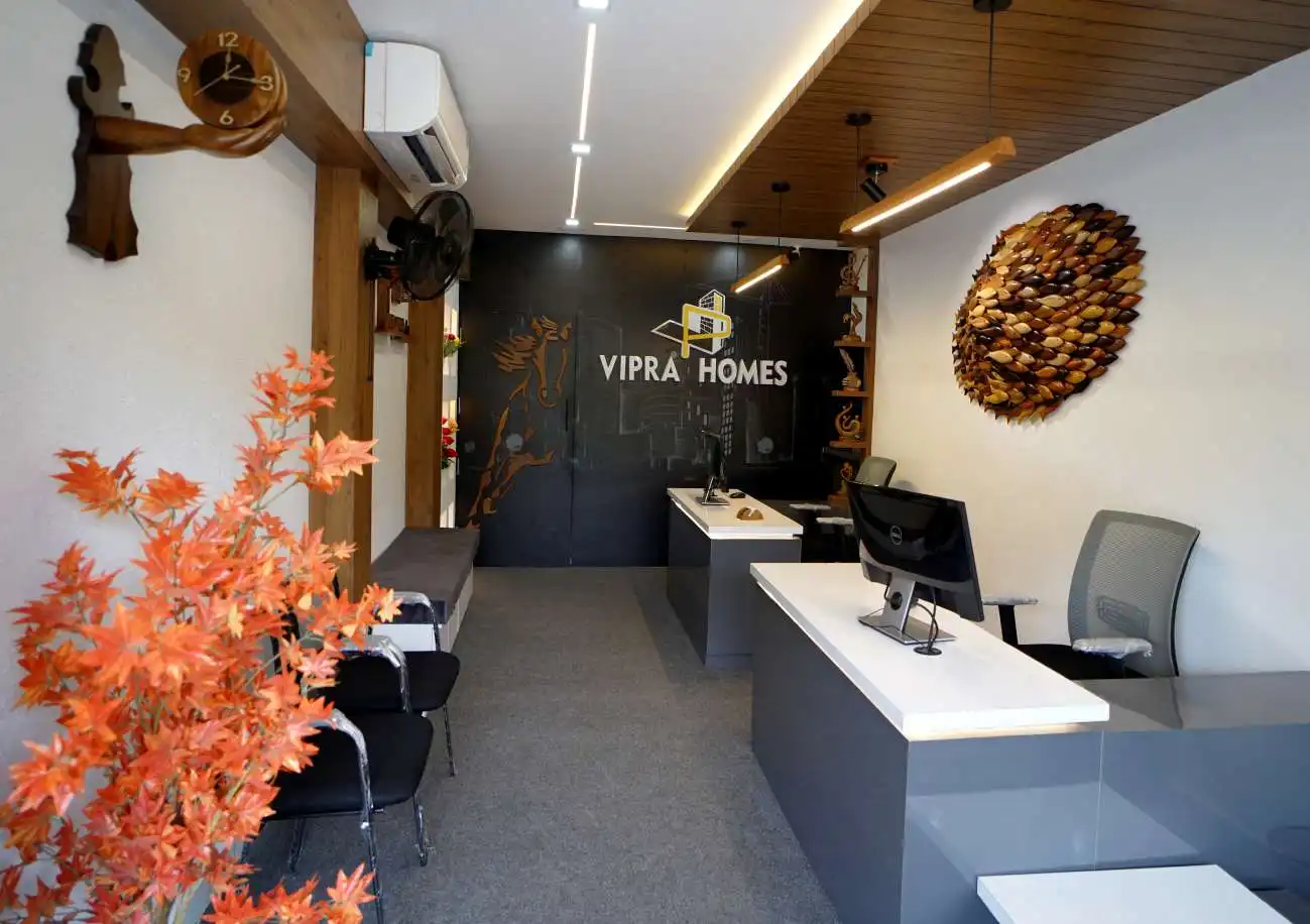 The VIPRA HOMES office reception, with the VIPRA HOMES logo on a dark feature wall
