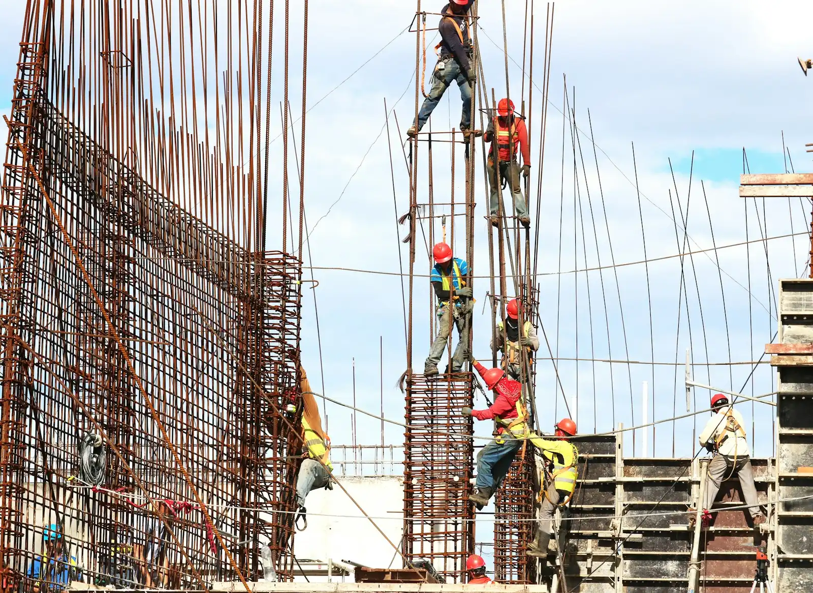 Construction workers fixing reinforcement for concrete columns on site