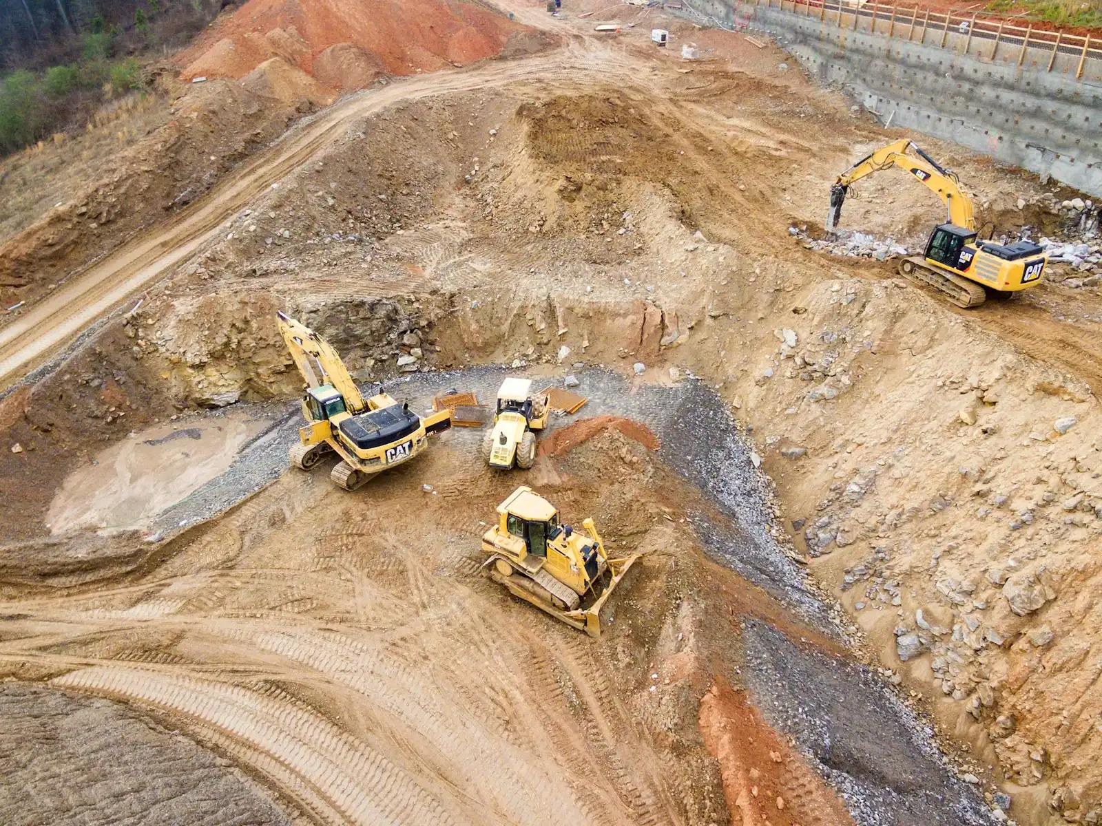 Aerial view of a site being graded with earth-moving machinery
